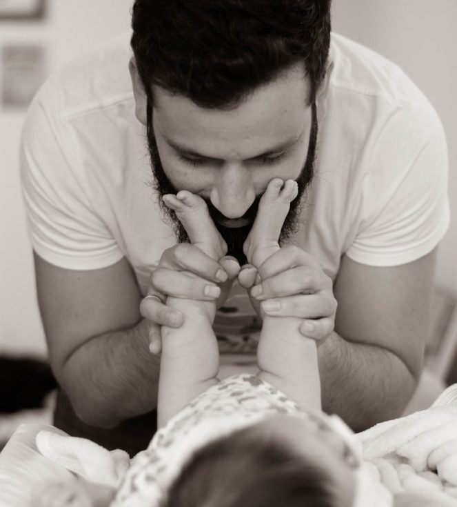 Photo by Felipe Salgado grayscale photography of man playing with baby