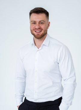 Confident,Man,In,White,Shirt.,A,Man,Stands,Indoors,Wearing Suks Minhas Male Fertility Expert