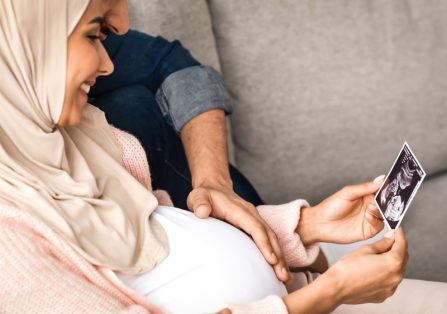 Happy,Pregnant,Arabic,Woman,And,Her,Husband,Looking,At,Baby